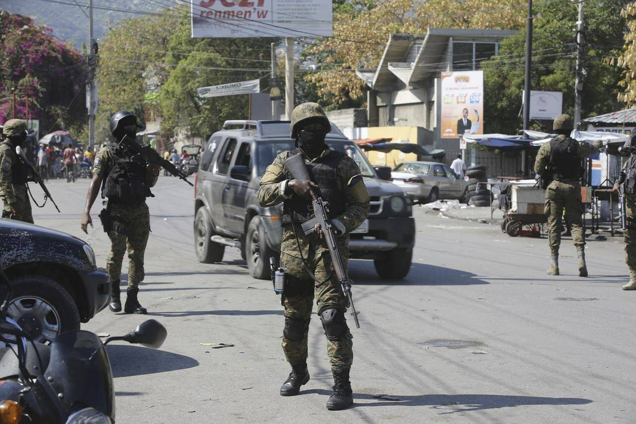 Members of the General Security Unit of the National Palace, USGPN, set up a security perimeter after armed gang members tried to seize the National Palace the day before, in Port-au-Prince, Haiti on March 9, 2024. THE CANADIAN PRESS/AP, Odelyn Joseph