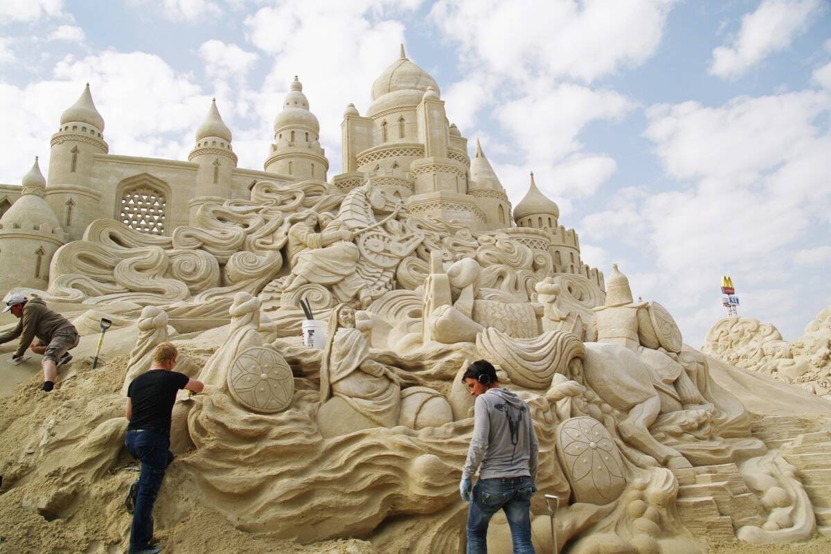 A decade ago, 72 professional sand sculptors set out to carve 30,000 tonnes of sand into a small town. Halfway through the project, a rainstorm hit. (Photo by Damon Langlois)