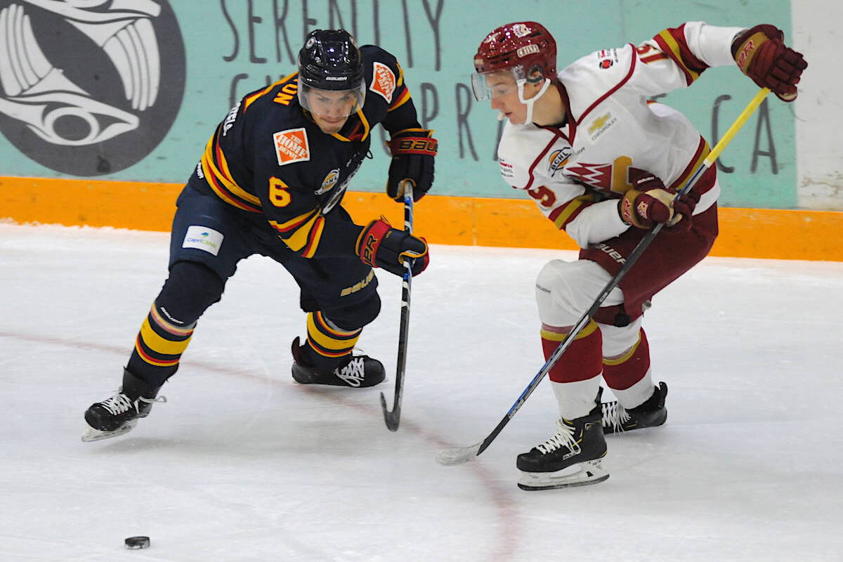 Christian Felton (left) of the Vernon Vipers battles Carter Wilkie of the Chilliwack Chiefs battles for the puck during a 2019 B.C. Hockey League game at the Chilliwack Coliseum. (Jenna Hauck - Black Press)