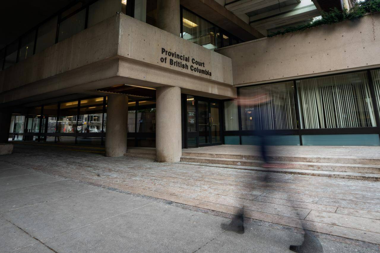 A person walks past the Provincial Court of British Columbia in Vancouver, B.C., Tuesday, Jan. 16, 2024. A B.C. judge has warned of what he calls a likely “tsunami” of Indigenous identity fraud in the courts, driven by the “desire” of non-Indigenous peoples to access what they deem to be benefits of identifying as Indigenous. THE CANADIAN PRESS/Ethan Cairns