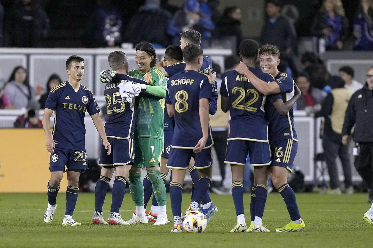 Vancouver Whitecaps players celebrate a 2-0 victory against the San Jose Earthquakes in an MLS soccer match in San Jose, Calif., Saturday, March 9, 2024. THE CANADIAN PRESS/AP, Tony Avelar