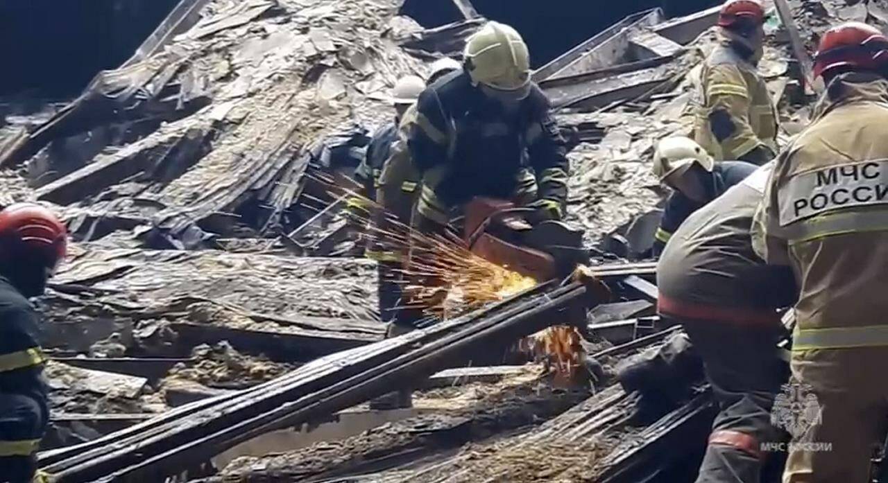 In this photo taken from video released by Russian Emergency Ministry Press Service on Sunday, March 24, 2024, rescuers work in the burned concert hall after a terrorists attack on the building of the Crocus City Hall on the western edge of Moscow, Russia. Russia’s top state investigative agency says the death toll in the Moscow concert hall attack has risen to 133. The attack Friday on Crocus City Hall, a sprawling mall and concert venue on Moscow’s western edge, also left many wounded and left the building a smoldering ruin. (Russian Emergency Ministry Press Service via AP)