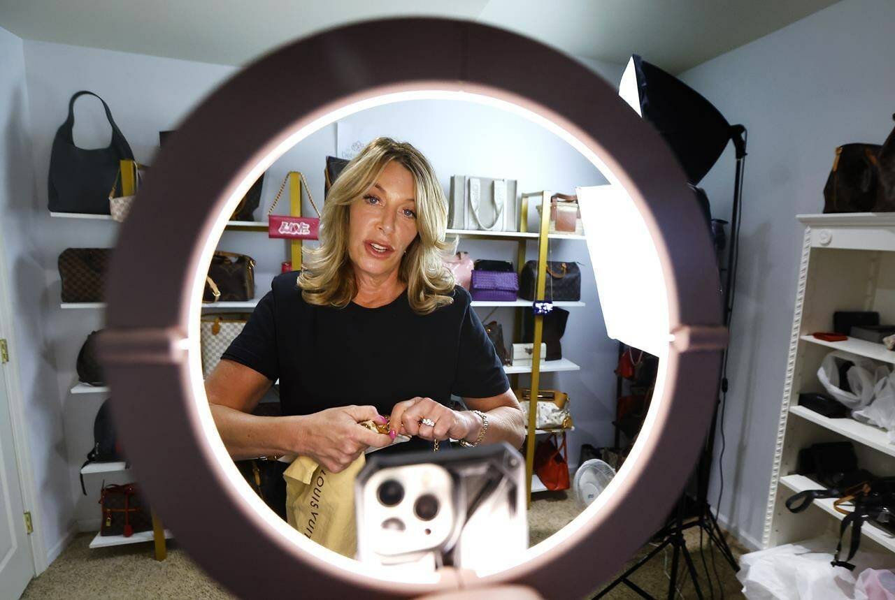 Deborah Mayer works on a livestream on TikTok on Wednesday, March 21, 2024, in Freehold, N.J. Mayer has sold new and pre-owned handbags and other designer goods out of her New Jersey home for 16 years. Early last year, TikTok recruited her business for the live component of TikTok Shop. (AP Photo/Noah K. Murray)