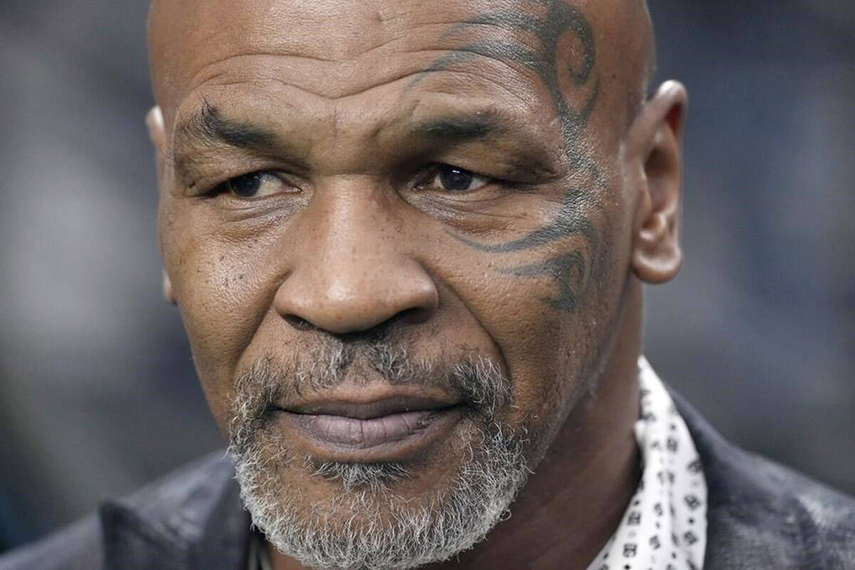 FILE - Former heavyweight boxing champion Mike Tyson stands on the field before an NFL football game between the Las Vegas Raiders and the Pittsburgh Steelers, Sept. 24, 2023, in Las Vegas. (AP Photo/Mark J. Terrill, File)