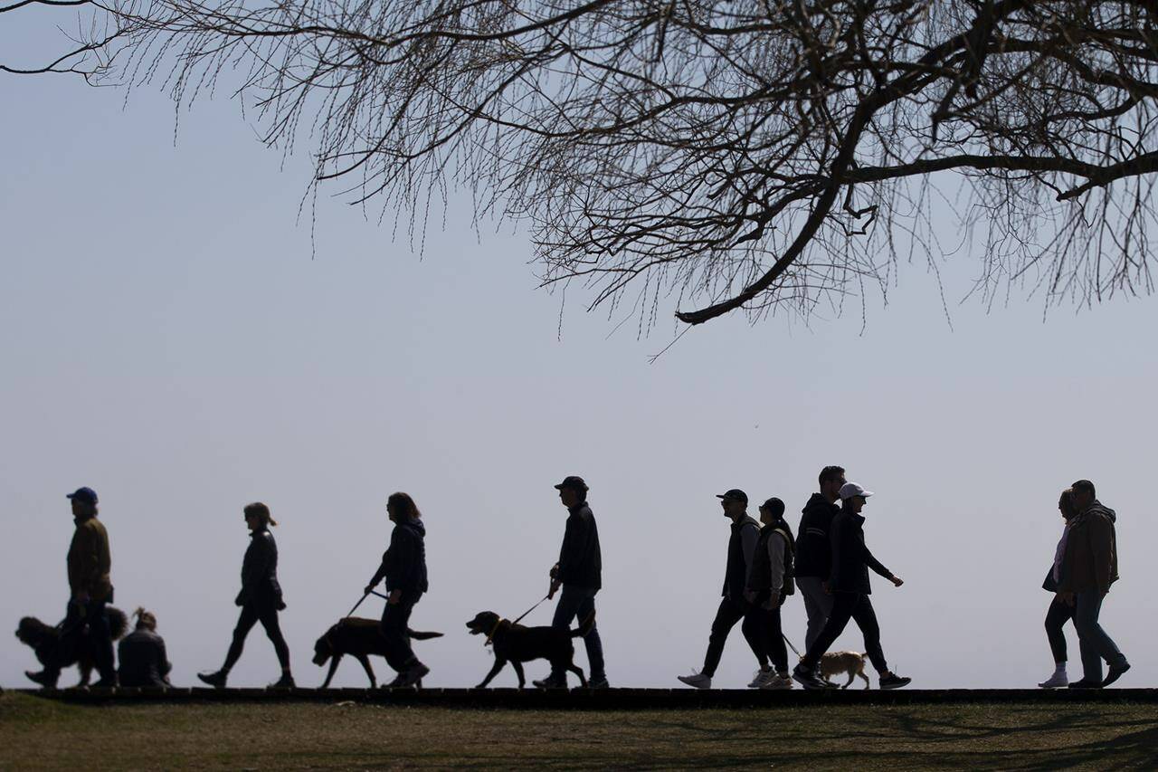 Statistics Canada says the country posted its highest annual population growth rate in more than six decades last year. People walk along the boardwalk in Toronto’s east end on Sunday, April 4 2021. THE CANADIAN PRESS/Chris Young