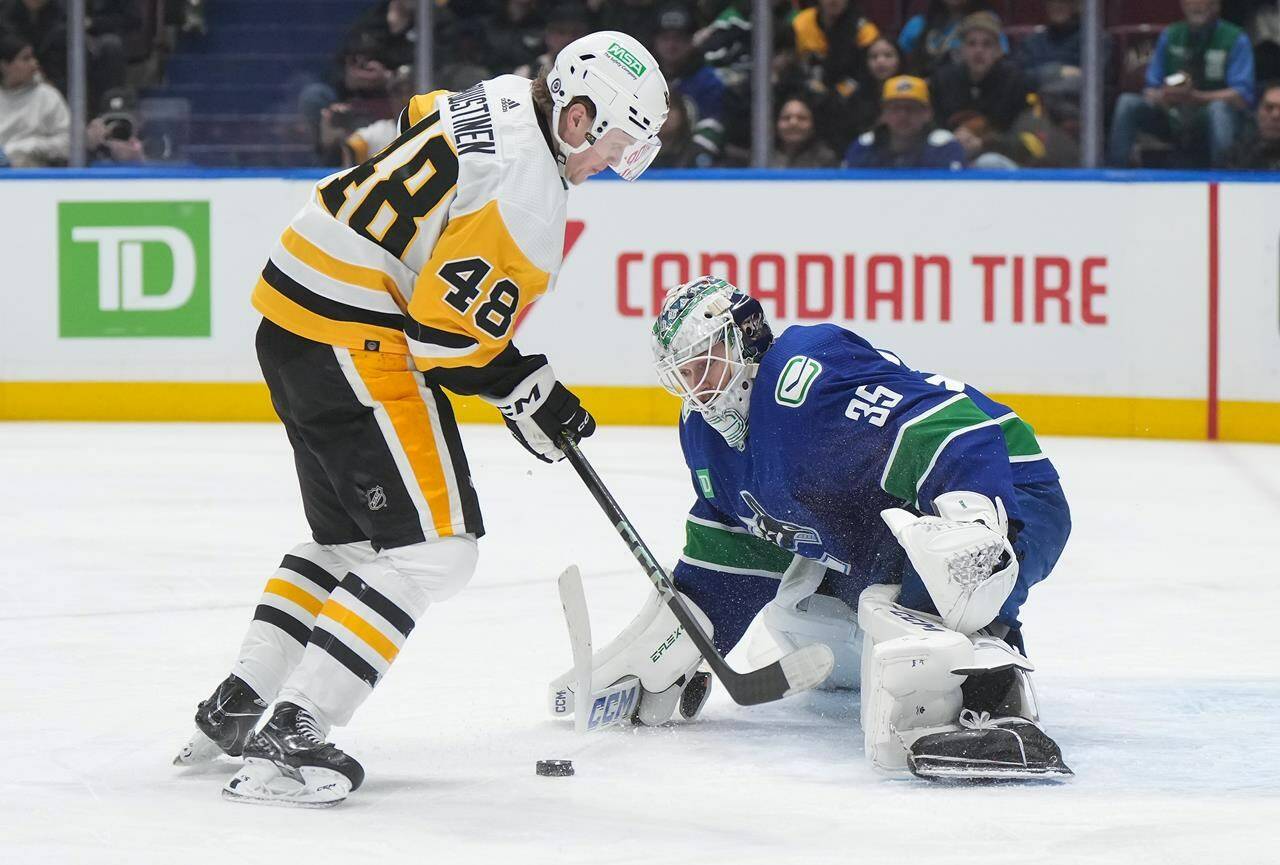 Vancouver Canucks goalie Thatcher Demko (35) stops Pittsburgh Penguins’ Valtteri Puustinen (48) during the first period of an NHL game in Vancouver, on Tuesday, February 27, 2024. The Canucks have placed all-star goalie Demko on the long-term injured reserve list retroactively.THE CANADIAN PRESS/Darryl Dyck