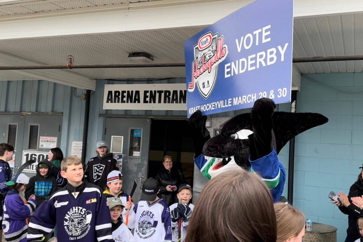 Vancouver Canucks mascot Fin hoists the Vote Enderby sign, as the mascot and former goaltender Kirk McLean paid a visit to Enderby Arena, in preparation for Kraft Hockeyville voting on Friday, March 29. (Bowen Assman - Morning Star)