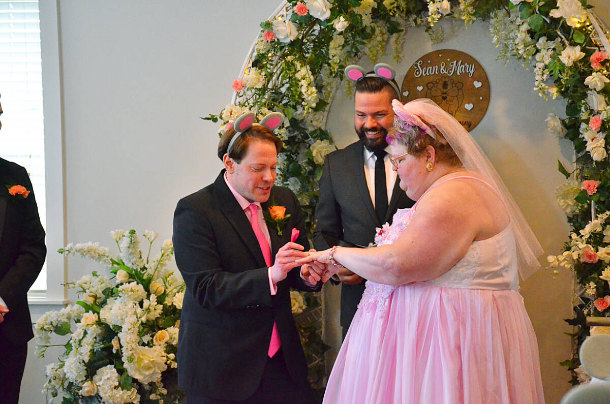 Sean Adelberg slips the ring on Mary Davidson’s ring during their wedding on tuesday, April 2 at Campbell River’s Hospice House. Photo by Alistair Taylor/Campbell River Mirror