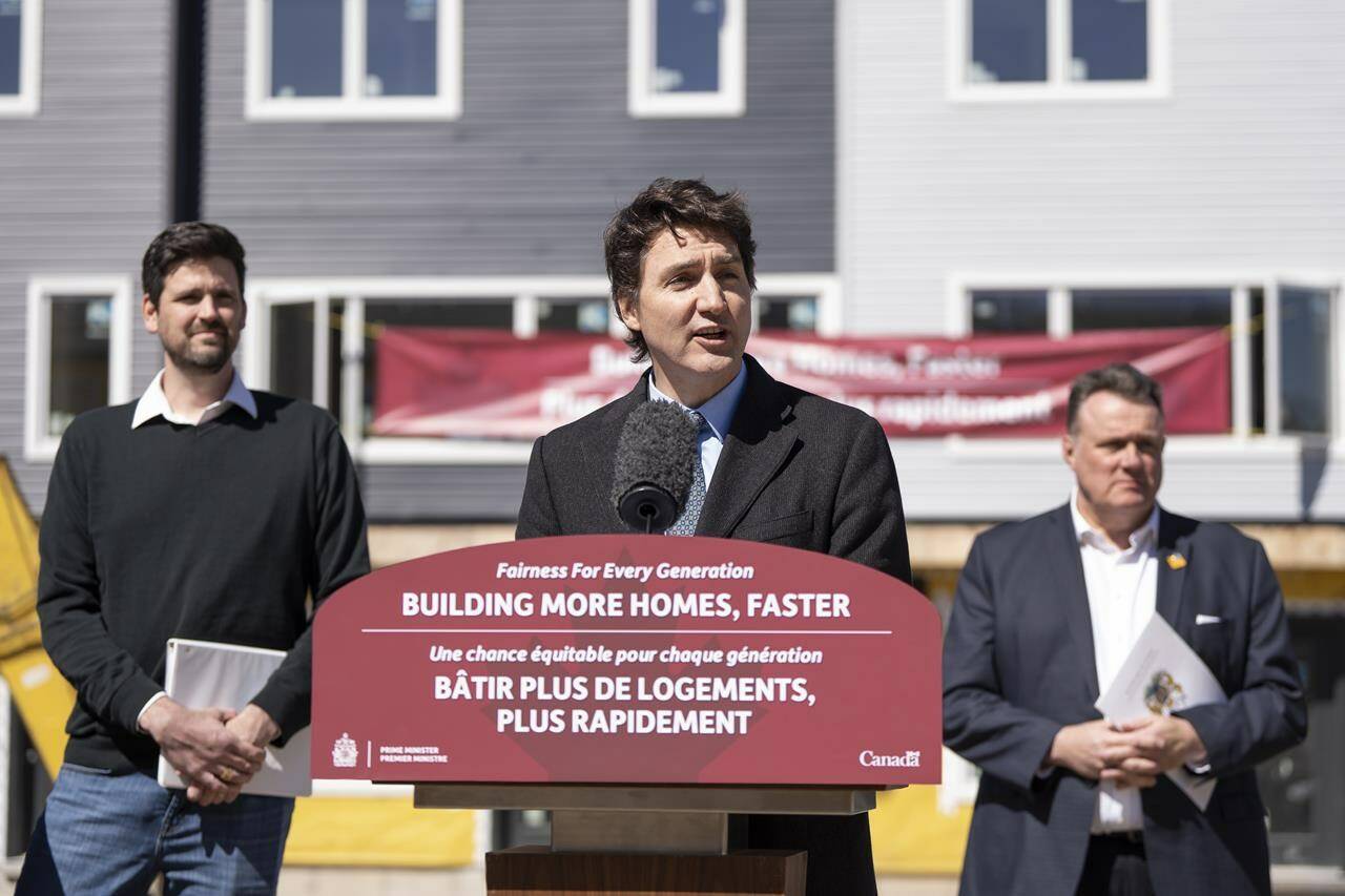 Prime Minister Justin Trudeau, centre, is flanked by Minister of Housing, Infrastructure and Communities Sean Fraser, left, and mayor of Halifax Mike Savage while making a housing announcement in Dartmouth, N.S. on Tuesday, April 2, 2024. THE CANADIAN PRESS/Darren Calabrese