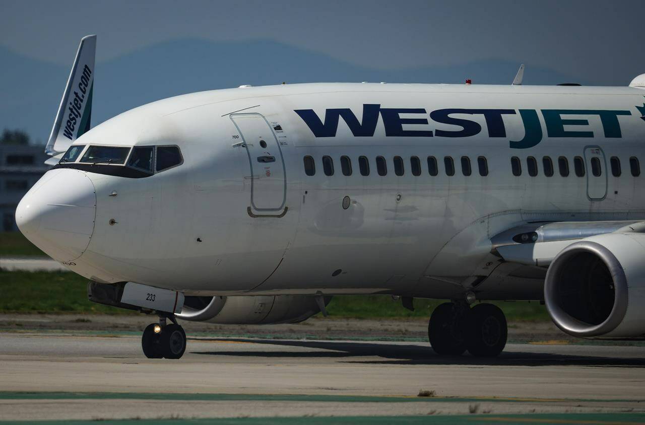A WestJet Boeing 737-700 aircraft taxis to the runway for departure from Vancouver International Airport, in Richmond, B.C., on Friday, May 19, 2023. WestJet Encore pilots could go on strike as soon as April 17 after they approved a strike mandate Tuesday. THE CANADIAN PRESS/Darryl Dyck