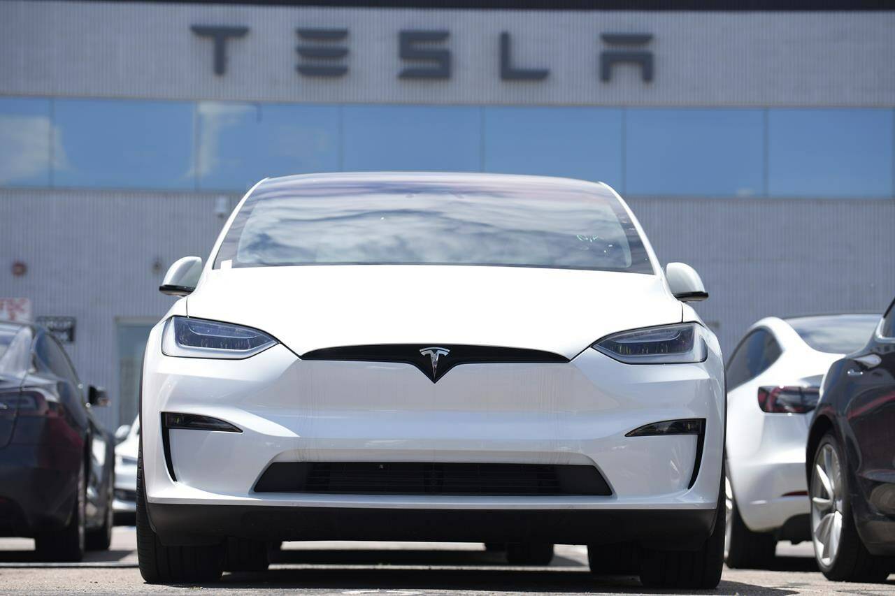 An Unsold 2023 Model X sports-utility vehicle sits outside a Tesla dealership Sunday, June 18, 2023, in Englewood, Colo. Tesla sales are expected to fall in the first quarter as demand for electric vehicles continues to slow. (AP Photo/David Zalubowski, File)