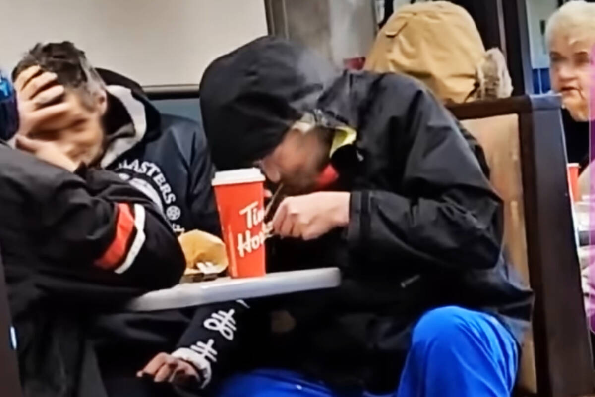 People who were said to be smoking hard drugs at the Tim Hortons Restaurant on 224th Street in Maple Ridge, in a still frame taken from a video. Their faces have been intentionally blurred. (Chelsa Meadus Facebook/Special to The News)
