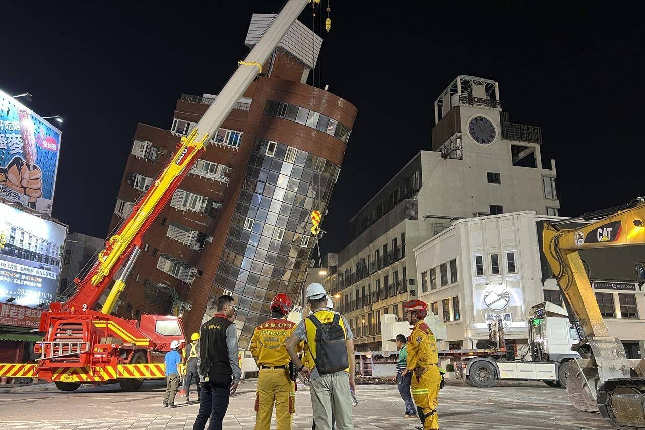 Rescue workers stand near the site of a leaning building in the aftermath of an earthquake in Hualien, eastern Taiwan, on Wednesday, April 3, 2024. Taiwan’s strongest earthquake in a quarter century rocked the island during the morning rush hour Wednesday, damaging buildings and highways. THE CANADIAN PRESS/AP-Johnson Lai