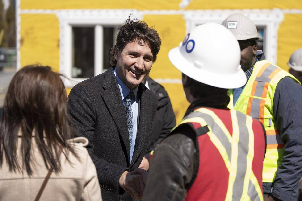 Prime Minister Justin Trudeau greets contractors following a housing announcement in Dartmouth, N.S. on Tuesday, April 2, 2024. Trudeau says a new $1.5-billion housing fund will help non-profit organizations acquire more rental units across Canada and make sure they remain affordable. THE CANADIAN PRESS/Darren Calabrese