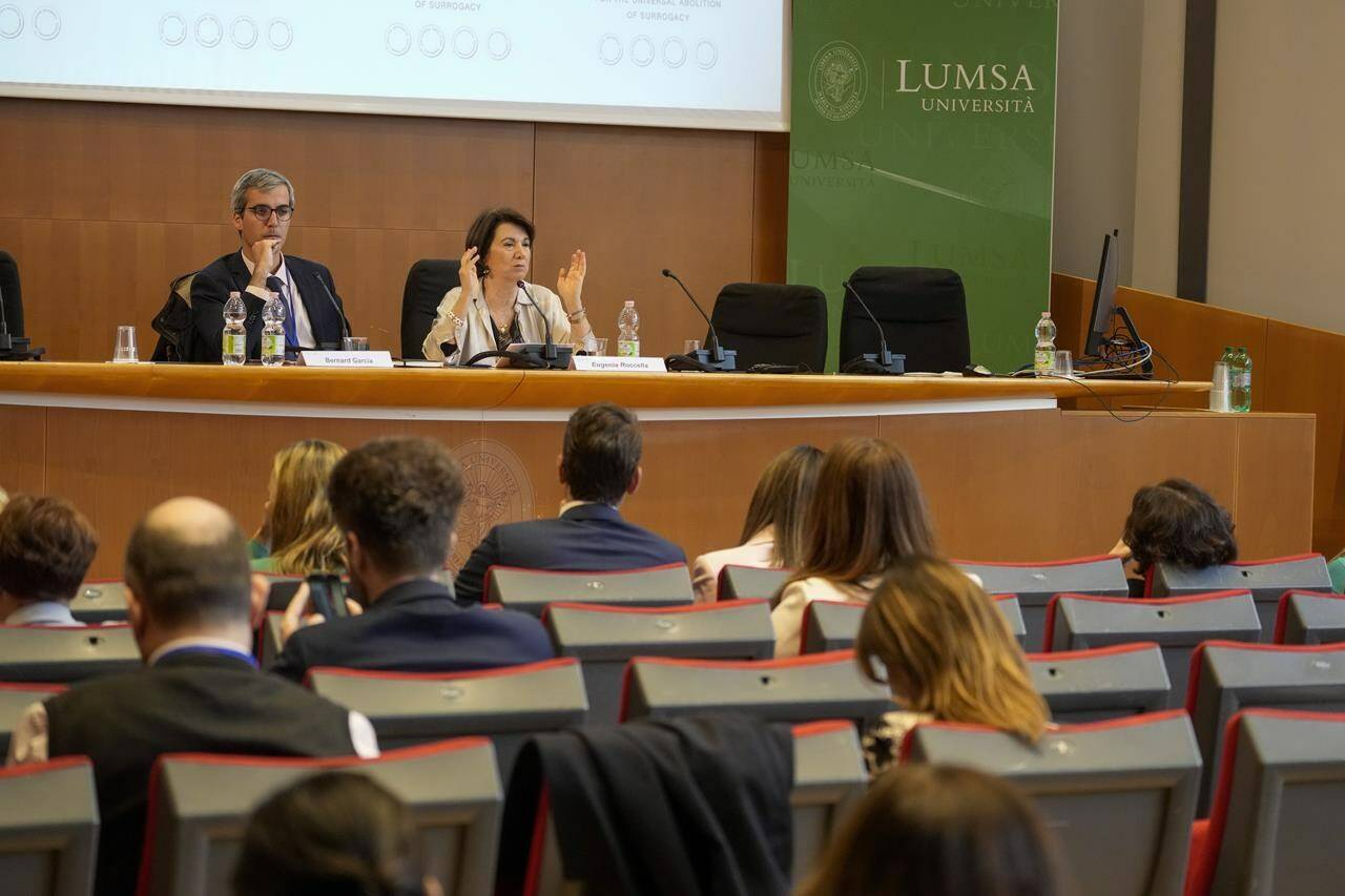 Conference coordinator Bernard Garcia and Italian Minister for birth, family and equal opportunities, Eugenia Roccella right, attend a two-day conference promoting an international treaty to outlaw surrogacy at the LUMSA Vatican-affiliated university, in Rome, Friday, April 5, 2024. The conference is promoting the international treaty to outlaw surrogacy based on the argument that the practice violates U.N. conventions protecting the rights of the child and surrogate mother. (AP Photo/Andrew Medichini)