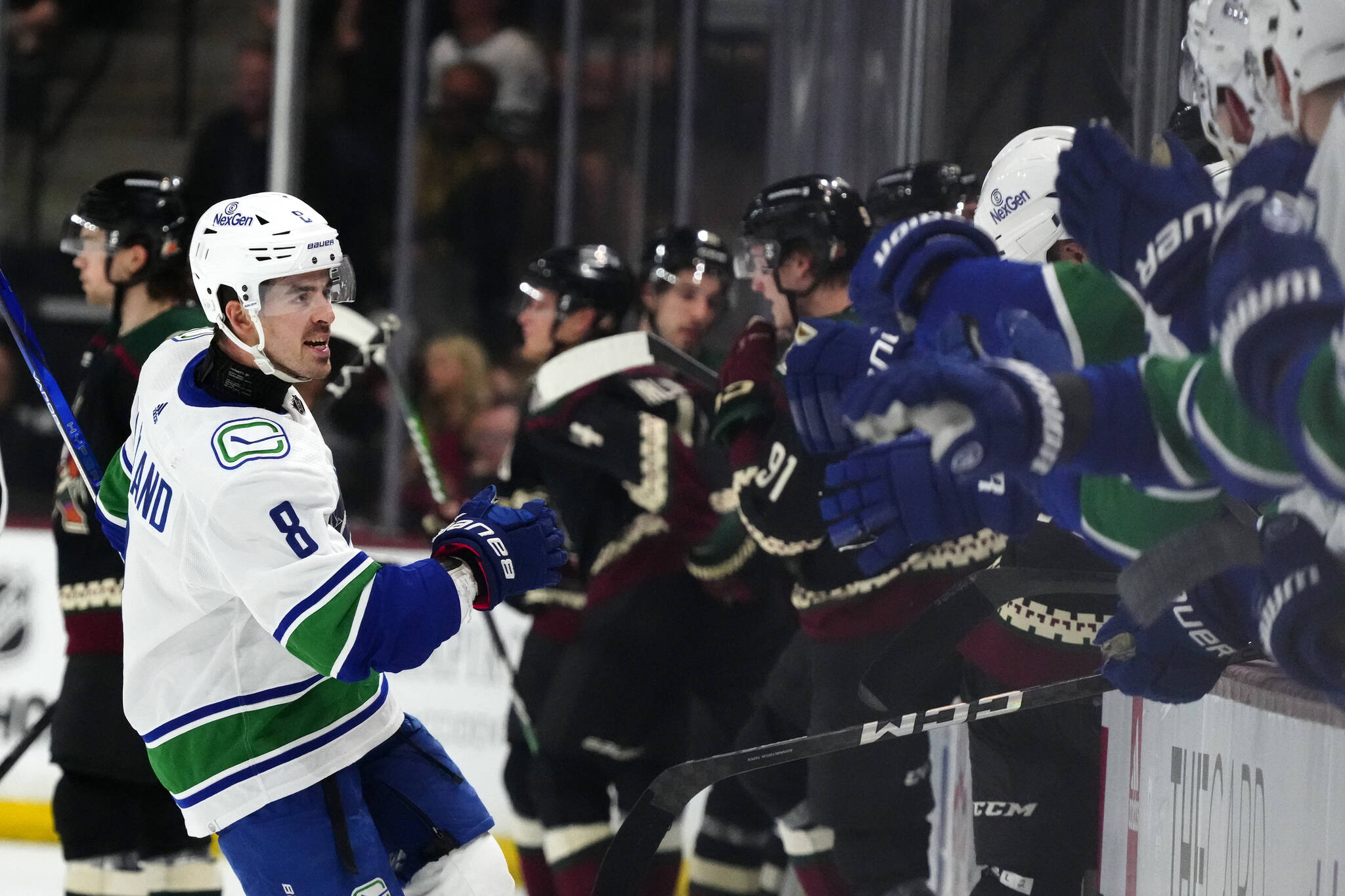 Vancouver Canucks right wing Conor Garland (8) celebrates his goal against the Arizona Coyotes during the third period of an NHL hockey game Wednesday, April 3, 2024, in Tempe, Ariz. The Canucks won 2-1. (AP Photo/Ross D. Franklin)