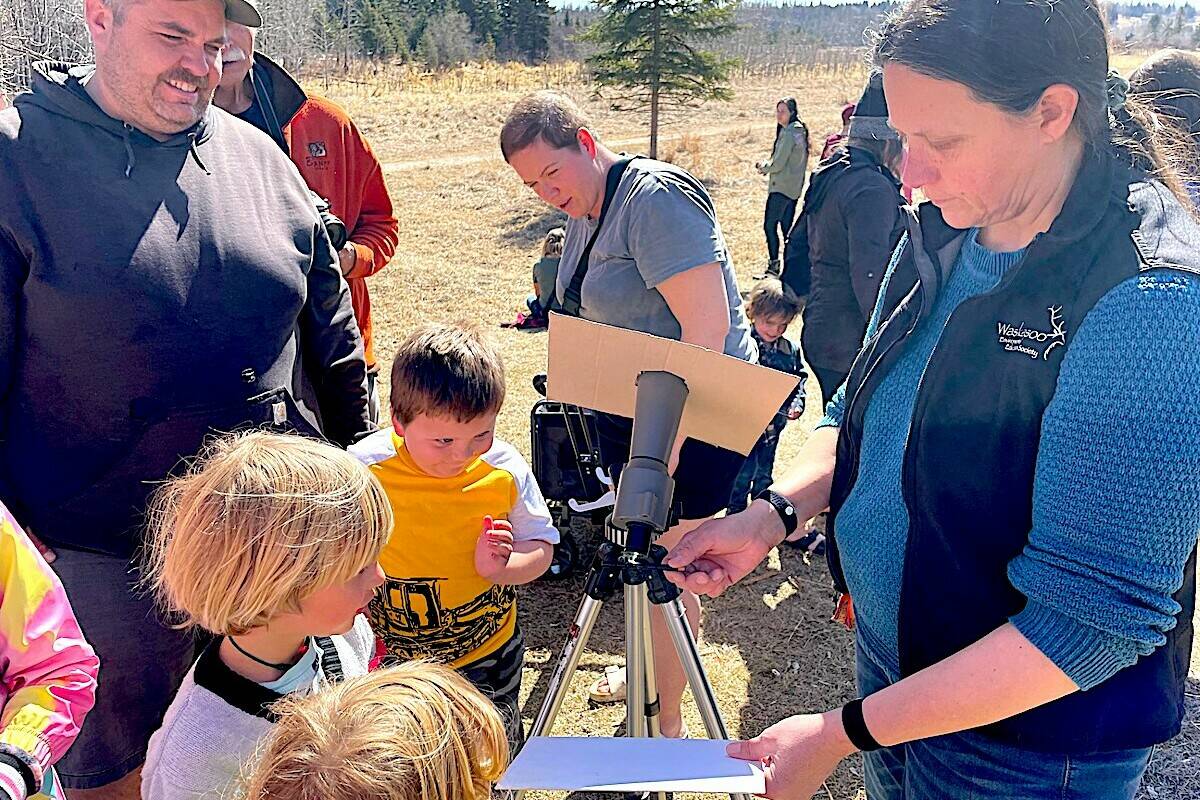 Kathryn Huedepohl, programmer with the Kerry Wood Nature Centre, shows how the heat of the sun’s rays can make a crayon smoke. (Photo by LANA MICHELIN/Advocate staff).