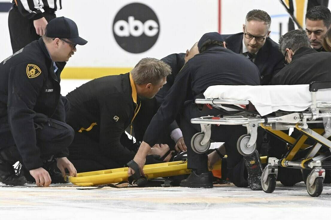 The medical staff tends to referee Steve Kozari after he and Tampa Bat Lightning’s Haydn Fleury collided in the third period of an NHL hockey game in Pittsburgh, Saturday, April 6, 2024. (Chaz Palla/Pittsburgh Tribune-Review via AP)