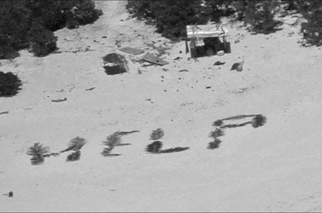 This photo provided by U.S. Coast Guard shows HELP” spelled out with palm fronds by three stranded mariners on Pikelot Atoll, Yap State, Federated States of Micronesia, Monday, April 8, 2024. The three mariners are safe after the coordination of U.S. Coast Guard Forces Micronesia/Sector Guam and the U.S. Navy, after being stranded for more than a week. (U.S. Coast Guard photo)