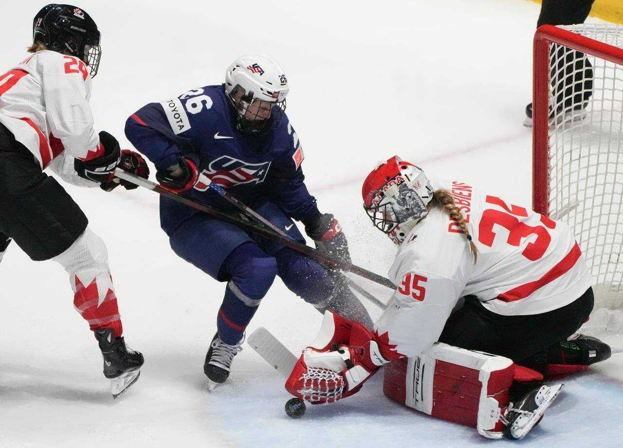 Canada goaltender Ann-Renee Desbiens (35) makes a save against United States’ Kendall Coyne Schofield (26) during second period gold medal hockey action at the IIHF Women’s World Hockey Championship in Utica, N.Y., Sunday, April 14, 2024. THE CANADIAN PRESS/Christinne Muschi