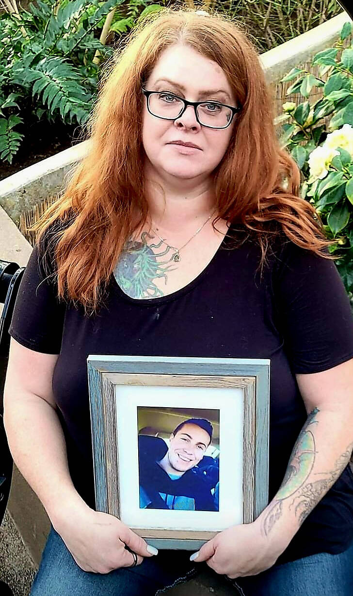 Tanya Hornbuckle holds a photo of her son Joel Wolstenholme, who fatally overdosed at his home in Edmonton on Feb. 6, 2022. THE CANADIAN PRESS/HO