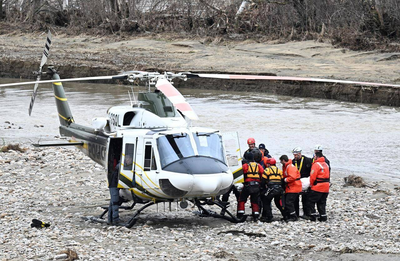 A coroner’s inquest into the deaths of two volunteer Quebec firefighters who perished during a flood rescue last May in the Charlevoix region is underway. Rescuers carry the body of one of the two missing firefighters to a helicopter <em>in Baie-Saint-Paul, Que., Wednesday, May 3, 2023. THE CANADIAN PRESS/Jacques Boissinot </em>