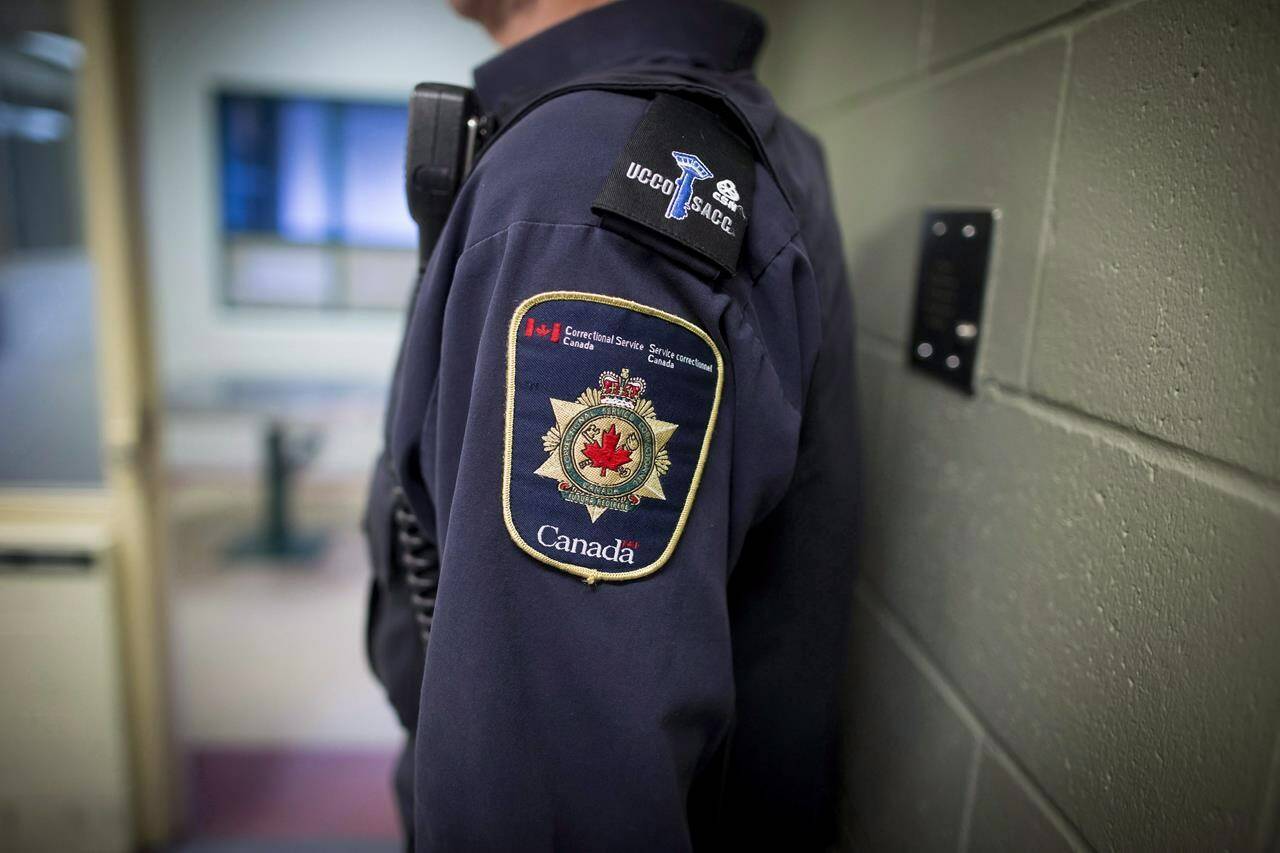 Patches are seen on the arm and shoulder of a corrections officer in Abbotsford, B.C., on Thursday Oct. 26, 2017. THE CANADIAN PRESS/Darryl Dyck