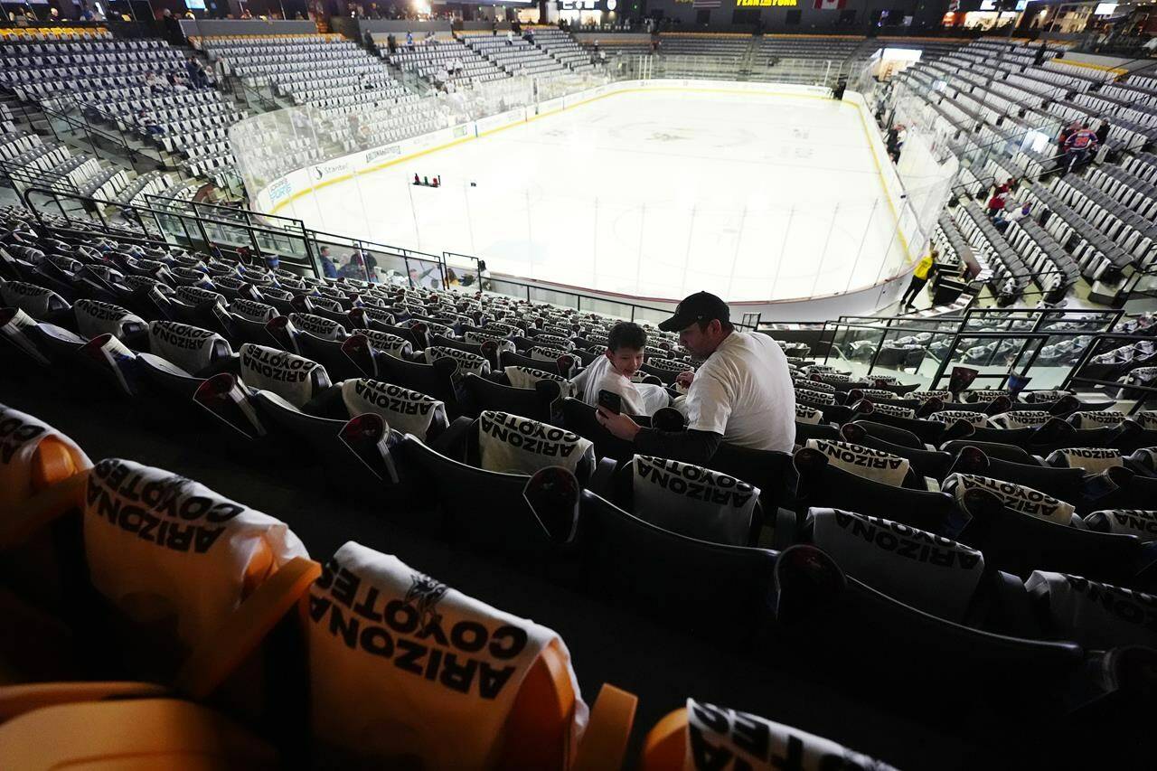 Arizona Coyotes fans start to find their seats at Mullett Arena prior to the team’s NHL hockey game against the Edmonton Oilers on Wednesday, April 17, 2024, in Tempe, Ariz. The team is expected to be sold and moved to Sale Lake City. (AP Photo/Ross D. Franklin)