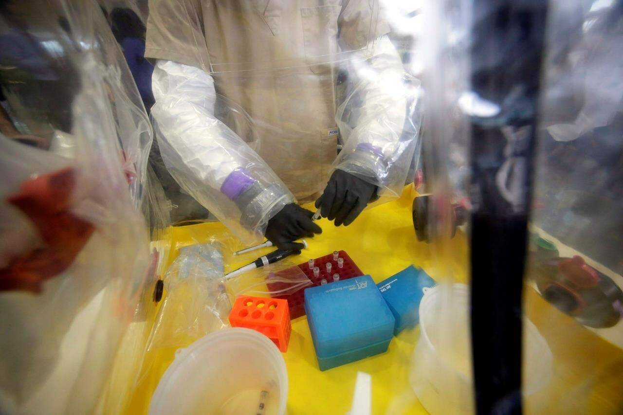 A lab technician works in a mobile lab at the National Microbiology Lab in Winnipeg on Nov. 3, 2014. THE CANADIAN PRESS/Pool, Reuters - Lyle Stafford
