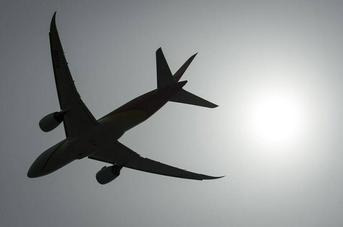 A plane is silhouetted as it takes off from Vancouver International Airport in Richmond, B.C., Monday, May 13, 2019. THE CANADIAN PRESS/Jonathan Hayward