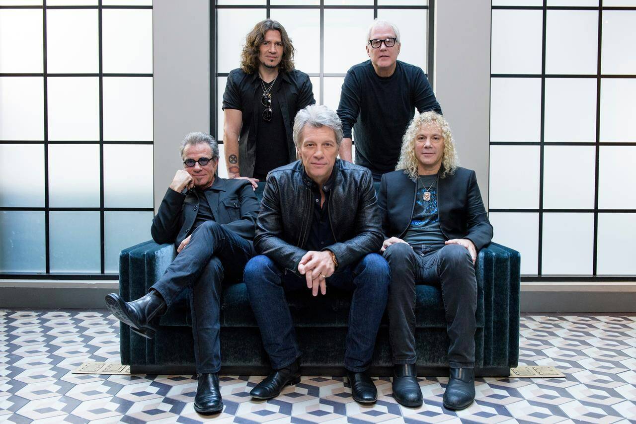 FILE - In this Oct. 19, 2016 file photo, members of Bon Jovi front row from left, Tico Torres, Jon Bon Jovi, David Bryan, back row from left, Phil X, and Hugh McDonald pose for a portrait in promotion of their album “This House is Not for Sale” in New York. Hulu is streaming a four-part docuseries “Thank You, Good Night: The Bon Jovi Story,” premiering April 26. (Photo by Drew Gurian/Invision/AP, File)