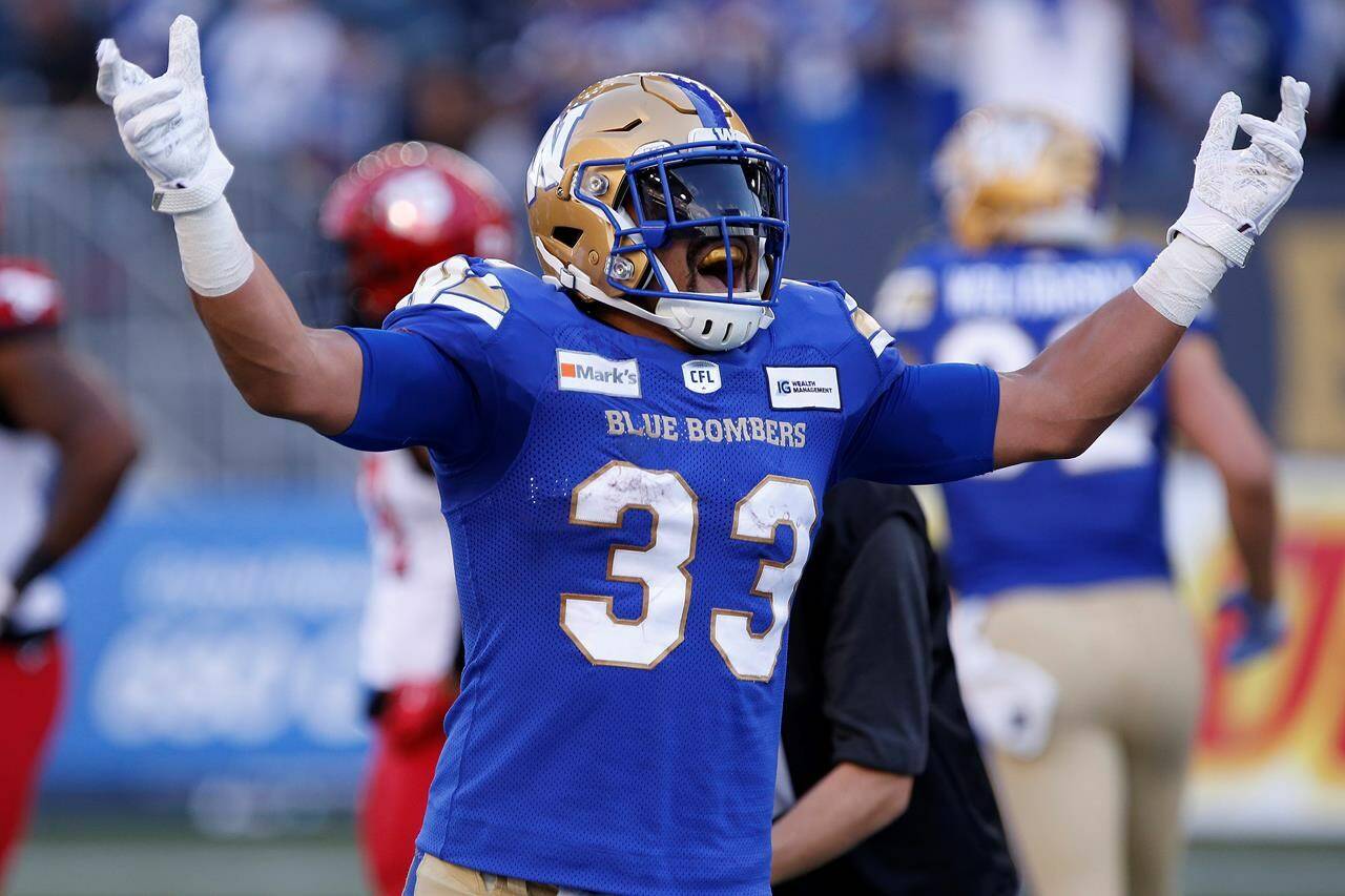 Winnipeg Blue Bombers’ Andrew Harris (33) celebrates his touchdown against the Calgary Stampeders during first half CFL football action in Winnipeg, Sunday, Aug. 29, 2021. Harris will finish his illustrious CFL career with his hometown team. Harris, 37, will sign a one-day contract Saturday to retire as a member of the Winnipeg Blue Bombers, the CFL team announced Friday. THE CANADIAN PRESS/John Woods