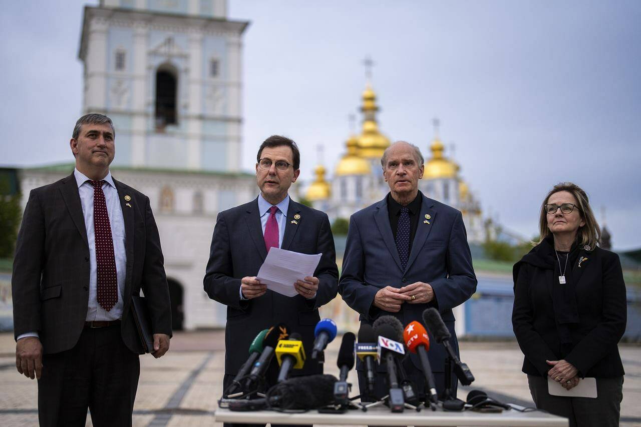 From left, U.S. representatives Nathaniel Moran, R-Tx, Tom Kean Jr, R-NJ, Bill Keating, D-Mass, and Madeleine Deane, D-Pa, talk to journalists during a joint news conference outside Saint Michael cathedral in Kyiv, Ukraine, Monday, April 22, 2024. A newly approved package of $61 billion in U.S. aid may prevent Ukraine from losing its war against Russia. But winning it will be a long slog. (AP Photo/Francisco Seco)