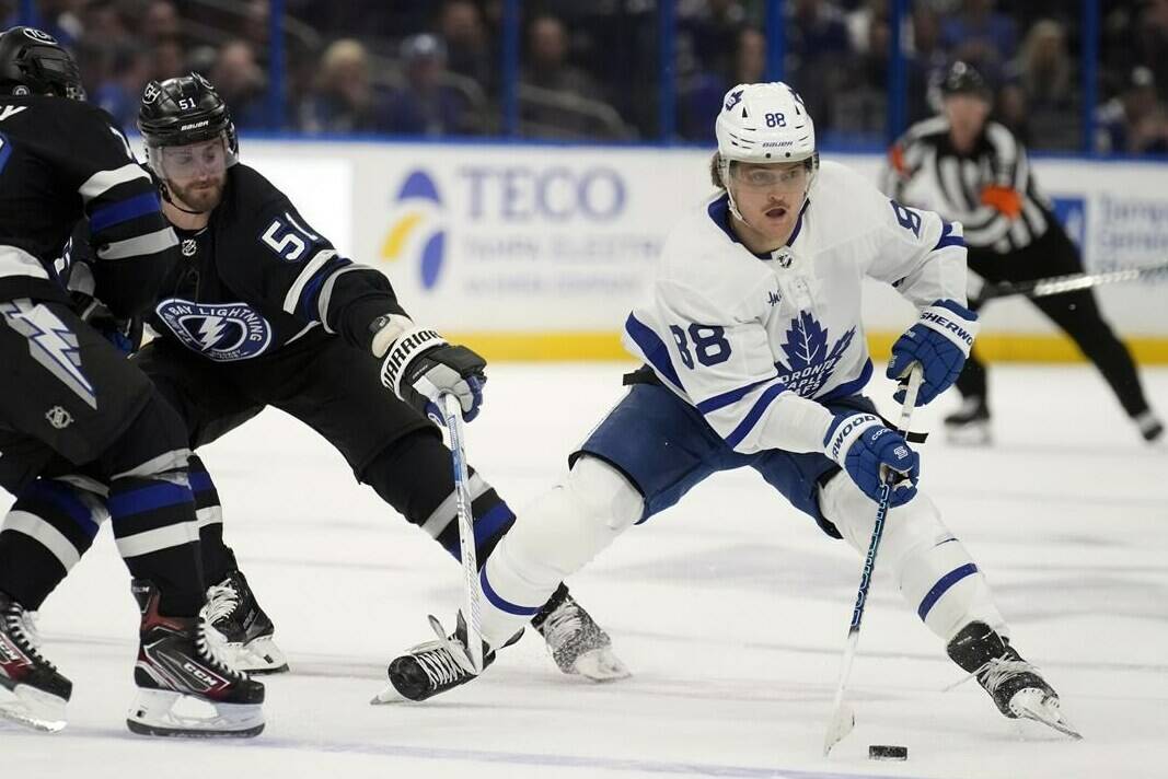 Toronto Maple Leafs right wing William Nylander (88) works around Tampa Bay Lightning left wing Austin Watson (51) and left wing Conor Sheary (73) during the first period of an NHL hockey game Wednesday, April 17, 2024, in Tampa, Fla. (AP Photo/Chris O’Meara)