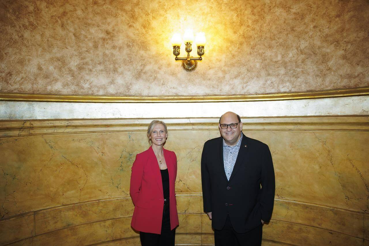 Theatre producer Michael Rubinoff poses alongside Tim Hortons executive Hope Bagozzi at the Elgin Theatre in Toronto, Tuesday, April 9, 2024. Tim Hortons is set to take centre stage with a new theatrical production. The fast-food chain says “The Last Timbit” will debut at the Elgin and Winter Garden Theatre in Toronto this June. THE CANADIAN PRESS/Cole Burston