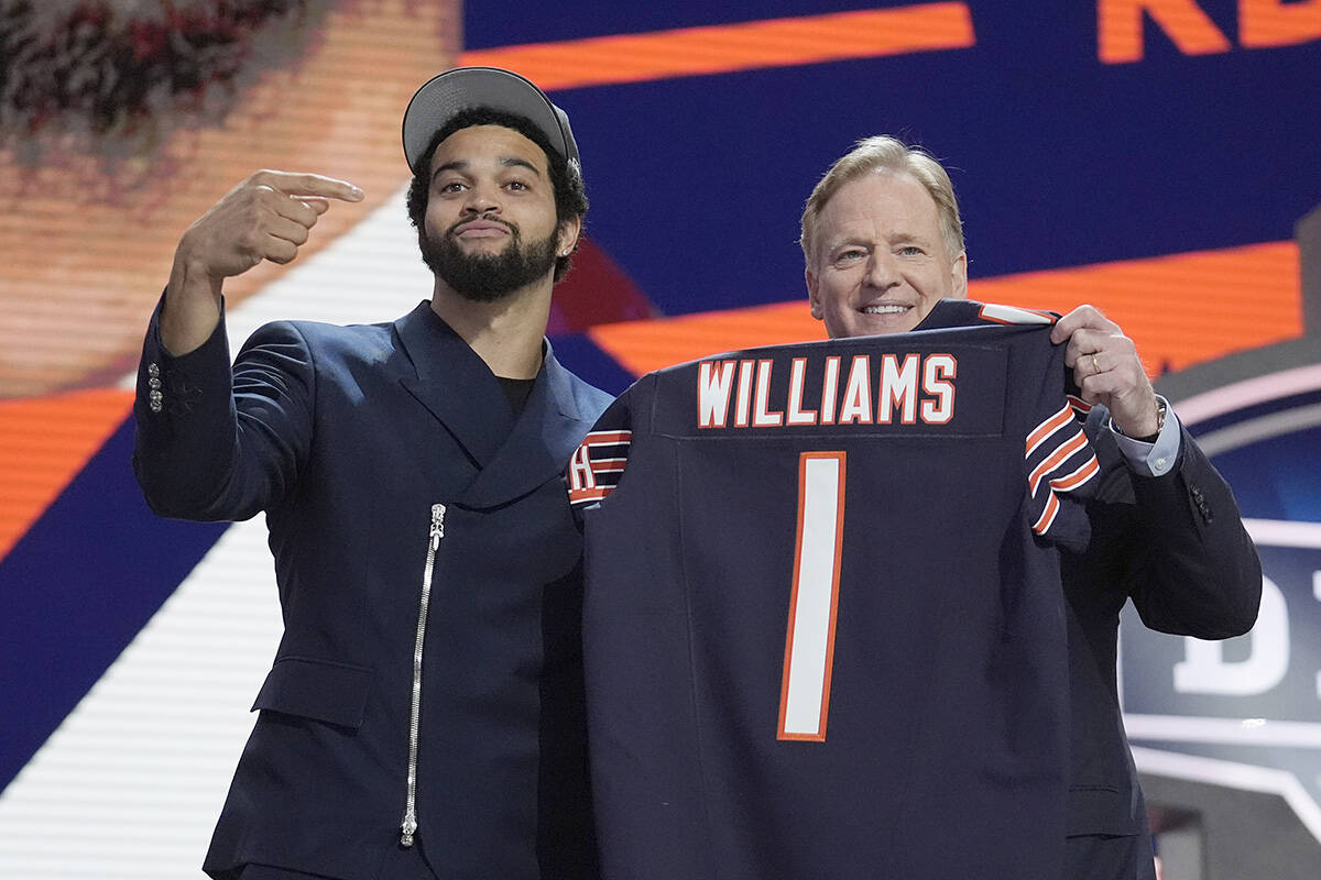 Southern California quarterback Caleb Williams celebrates with NFL commissioner Roger Goodell after being chosen by the Chicago Bears with the first overall pick during the first round of the NFL football draft, Thursday, April 25, 2024, in Detroit. (AP Photo/Jeff Roberson)