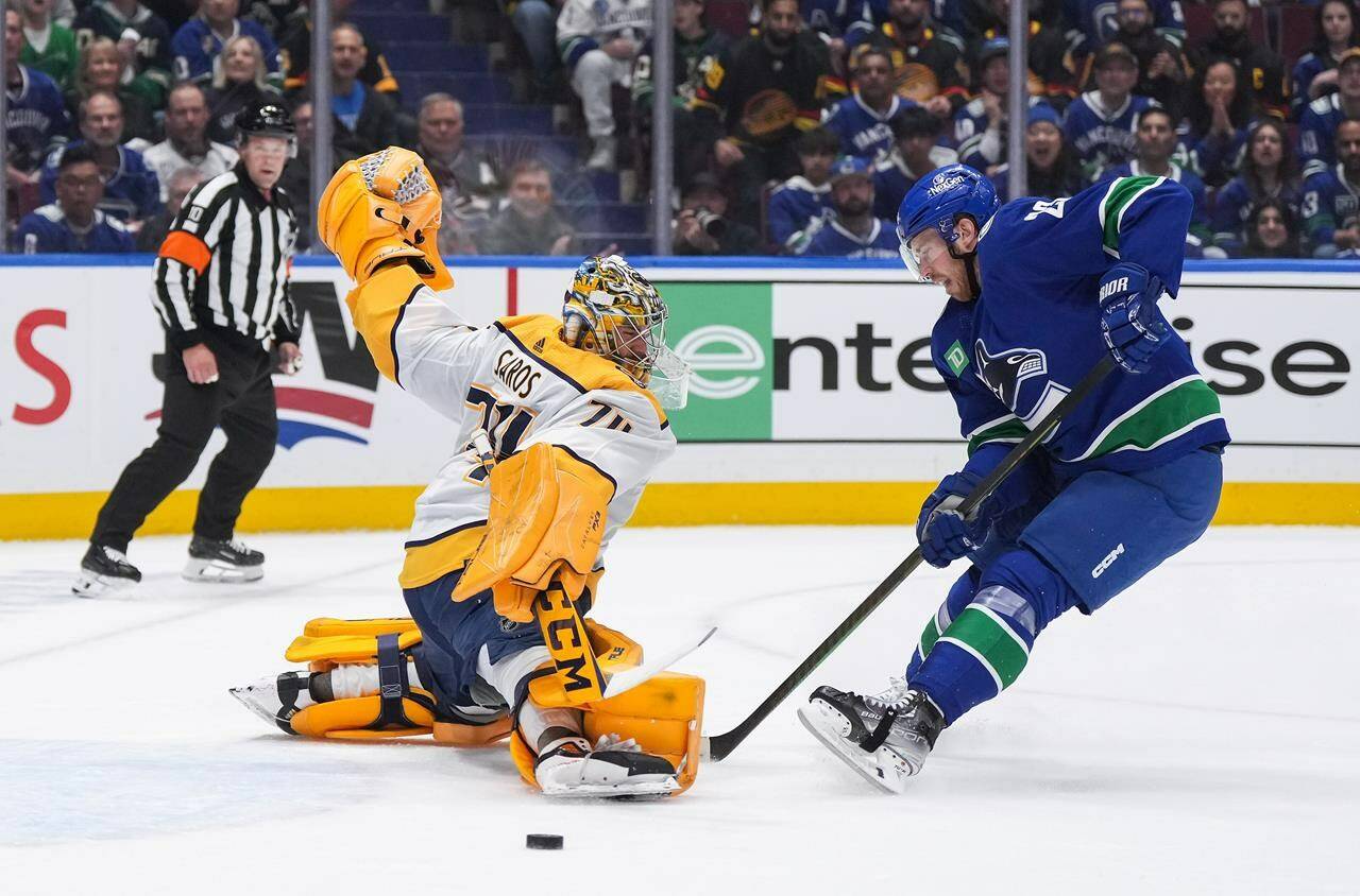 Nashville Predators goalie Juuse Saros, left, stops Vancouver Canucks’ Elias Lindholm during the first period in Game 1 of an NHL hockey Stanley Cup first-round playoff series, in Vancouver, on Sunday, April 21, 2024. THE CANADIAN PRESS/Darryl Dyck