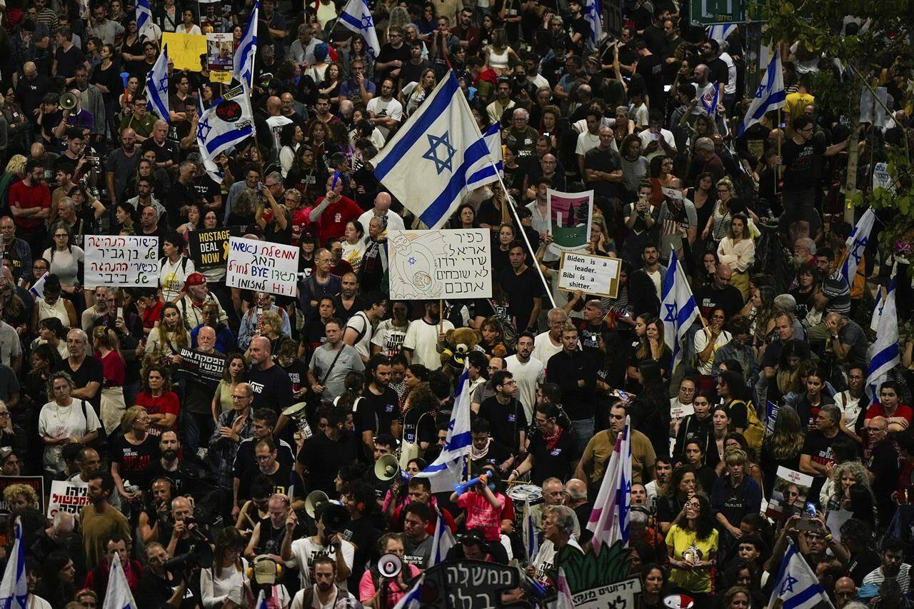 People protest against Israeli Prime Minister Benjamin Netanyahu’s government and call for the release of hostages held in the Gaza Strip by the Hamas militant group in Tel Aviv, Israel, Saturday, April 27, 2024. (AP Photo/Ohad Zwigenberg)