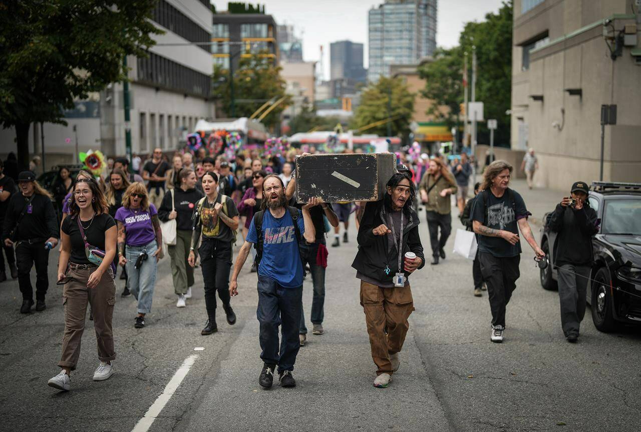 Drug user advocates are raising concerns over British Columbia’s request for Health Canada to give police power to step in when they see illicit drug use in public spaces, saying it may be a step backward in the fight against the deadly opioid crisis. Andrew Leavens, front left, and Carl Gladue, front right, carry an empty coffin during a march organized by the Vancouver Area Network of Drug Users (VANDU) to mark International Overdose Awareness Day, in Vancouver, B.C., Thursday, Aug. 31, 2023. THE CANADIAN PRESS/Darryl Dyck