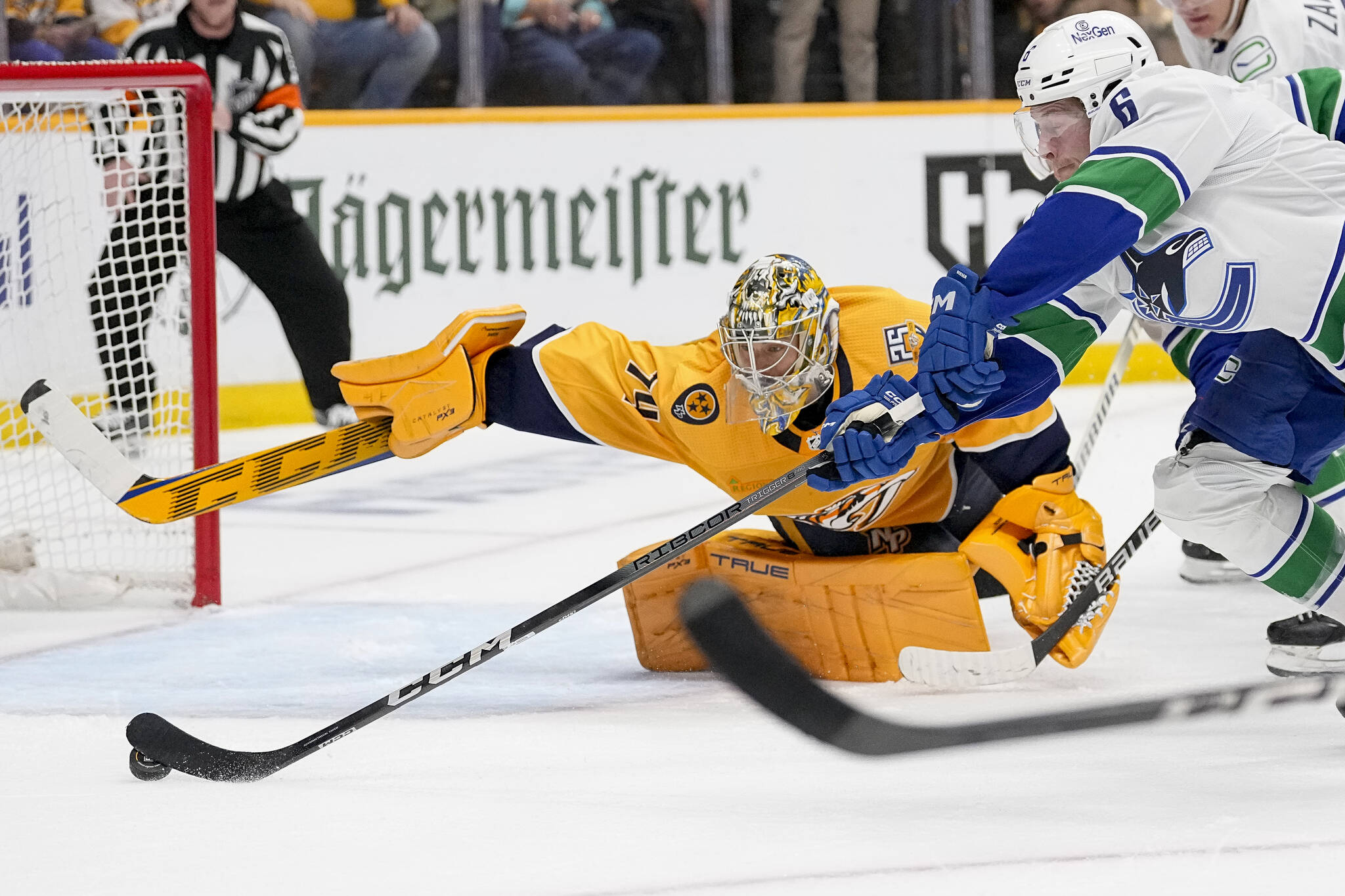 Vancouver Canucks right wing Brock Boeser (6) shoots the puck past Nashville Predators goaltender Juuse Saros (74) during the third period in Game 4 of an NHL hockey Stanley Cup first-round playoff series Sunday, April 28, 2024, in Nashville, Tenn. The Canucks won 4-3 in overtime. (AP Photo/George Walker IV)