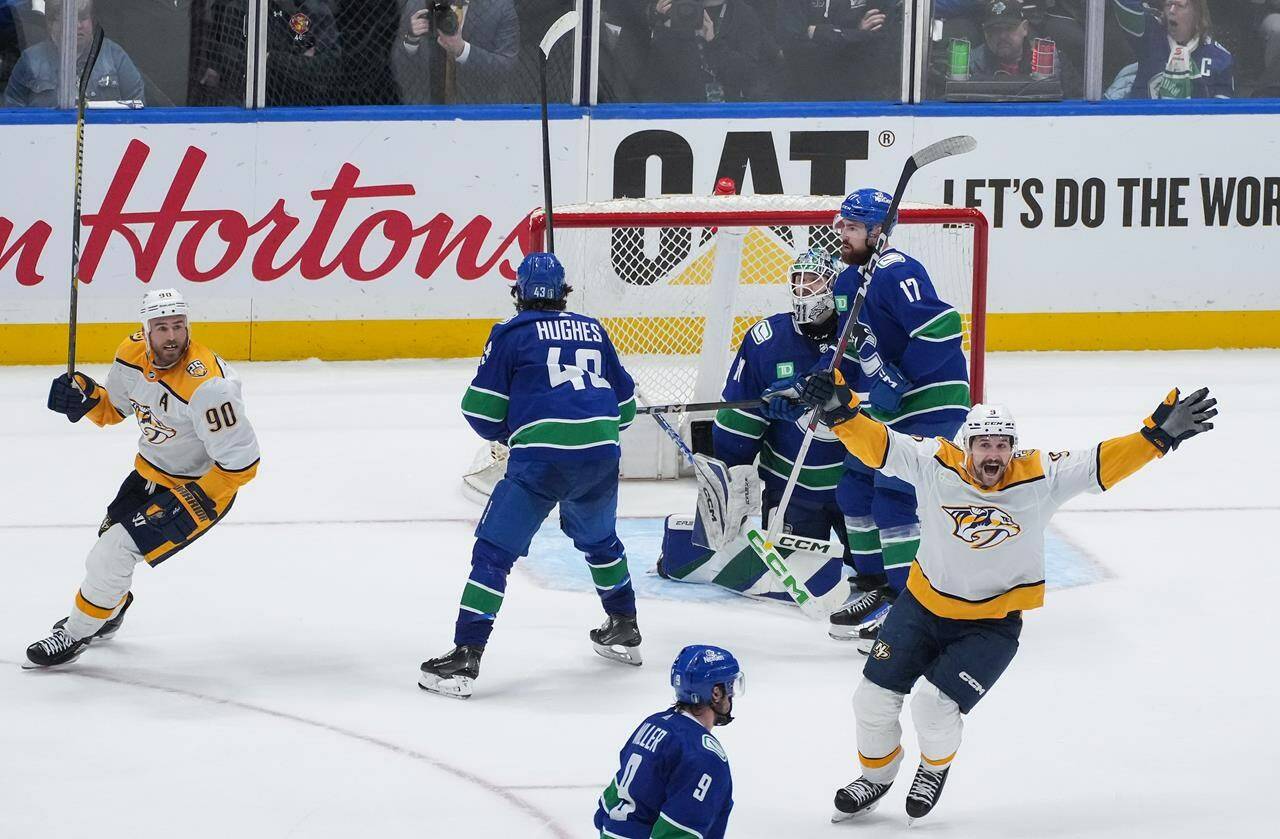 Nashville Predators’ Filip Forsberg, front right, and Ryan O’Reilly (90) celebrate a goal by Alexandre Carrier, not seen, against Vancouver Canucks goalie Arturs Silovs, back right, as Filip Hronek (17) and Quinn Hughes (43) look on during the third period in Game 5 of an NHL hockey Stanley Cup first-round playoff series, in Vancouver, on Tuesday, April 30, 2024. THE CANADIAN PRESS/Darryl Dyck