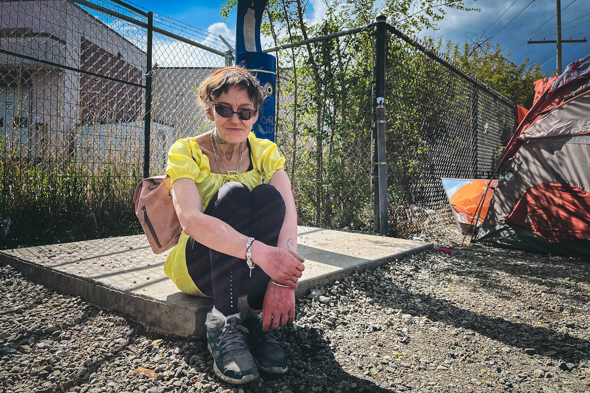 Tent City resident Paula Chartrand sits next to the broken tap. (Jacqueline Gelineau/ Capital News)