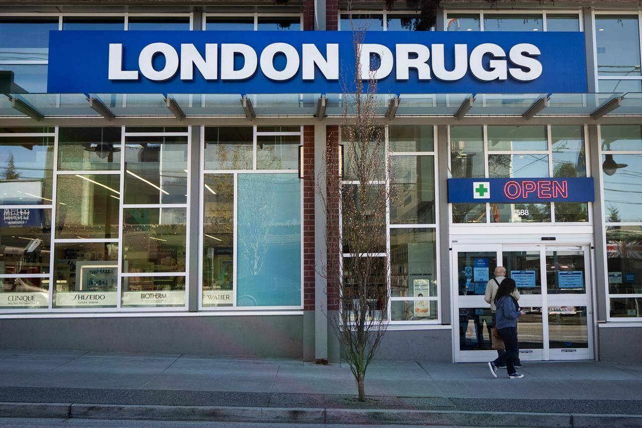 People wait outside of the London Drugs Dunbar location on Monday, April. 29, 2024. London Drugs says its phone lines are operational again after being taken offline in response to a cybersecurity incident. THE CANADIAN PRESS/Ethan Cairns