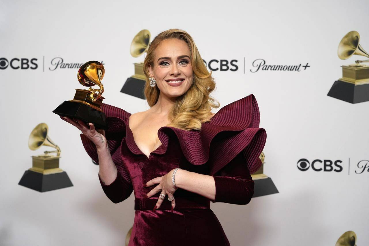 FILE - Adele, winner of the award for best pop solo performance for “Easy on Me,” poses in the press room at the 65th annual Grammy Awards on Feb. 5, 2023, in Los Angeles. Artists from Universal Music Group, which include Drake, Adele, Bad Bunny and Billie Eilish, will be returning to TikTok as the two parties have struck a new licensing agreement following an approximately three-month long dispute. (AP Photo/Jae C. Hong, File)