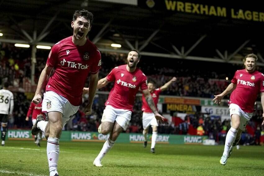 Wrexham’s Tom O’Connor celebrates scoring against Sheffield United during the English FA Cup fourth round soccer match at The Racecourse Ground, Wrexham, Wales, Sunday Jan. 29, 2023. (Peter Byrne/PA via AP)