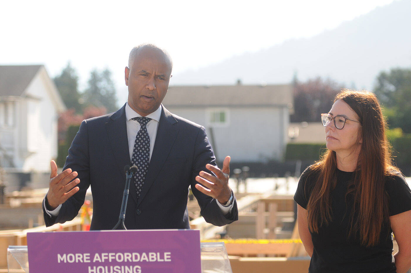 Kathleen Mosa, former executive director of Wilma’s Transition Society, is being sued by the society for misappropriation. Mosa looks at Housing Minister Ahmed Hussen in this file shot at an affordable housing announcement in Chilliwack on Thursday, July 28, 2022. (Jenna Hauck/ Chilliwack Progress file)