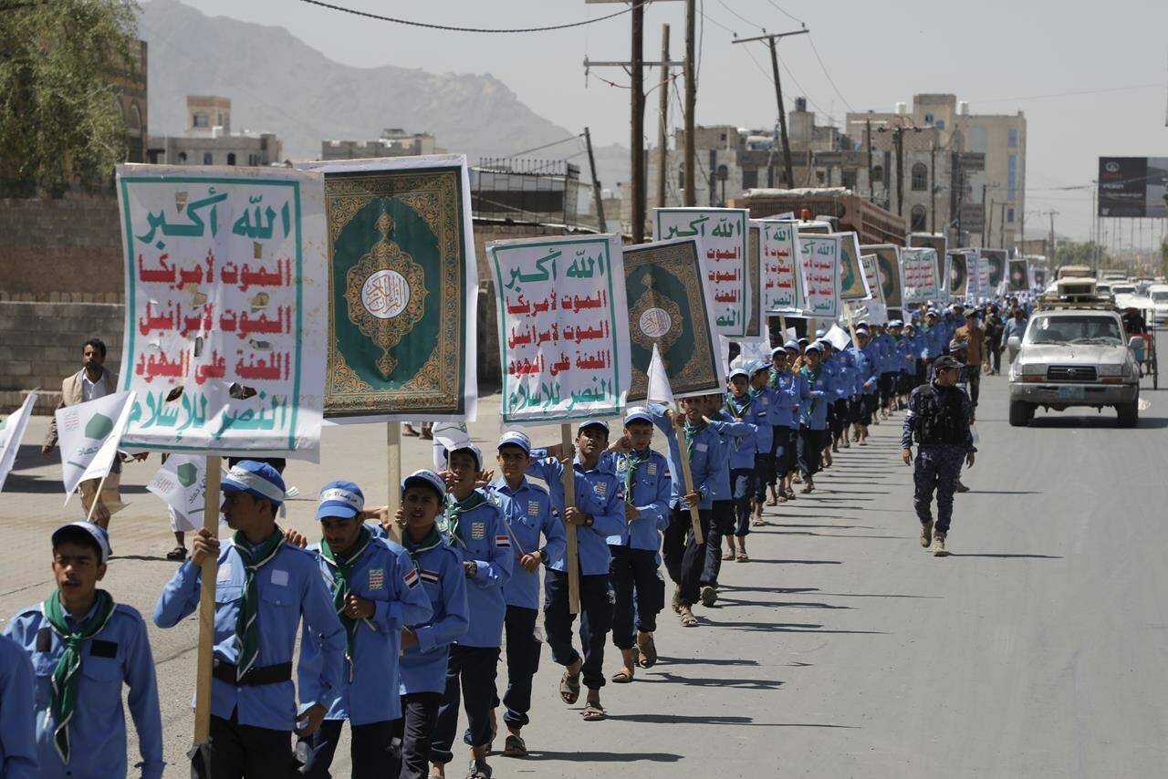 Yemeni students carry anti-Israel and anti-U.S. banners during a march organized by Houthis, to show solidarity with Palestinians in the Gaza Strip, in Sanaa, Yemen, Sunday, May 5, 2024. The Arabic reads, “God is great, Death to Israel, Death to America”. (AP Photo/Osamah Abdulrahman)