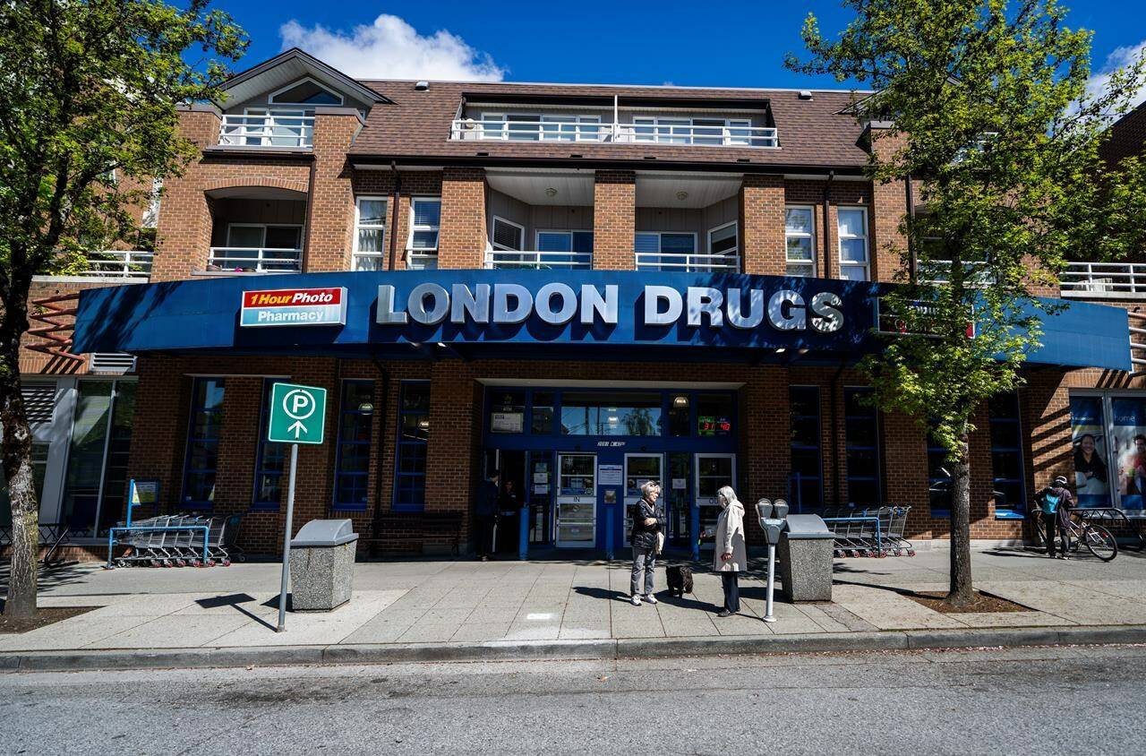 People wait outside of the London Drugs Kerrisdale location on Monday, April. 29, 2024. London Drugs says it is gradually reopening its stores following a cybersecurity incident that’s shut all of its more than 80 locations across Alberta, Saskatchewan, Manitoba and B.C. THE CANADIAN PRESS/Ethan Cairns