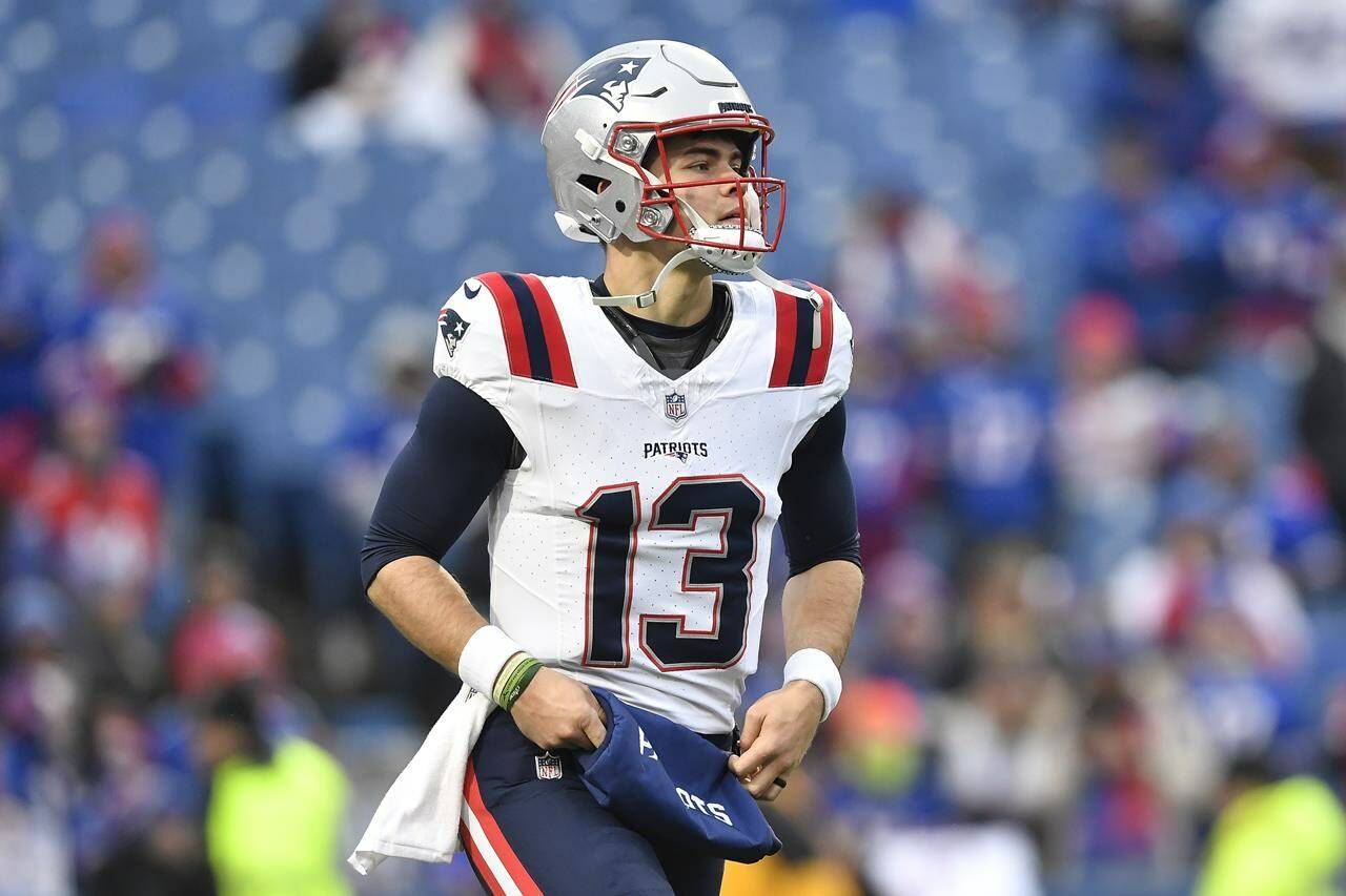 New England Patriots quarterback Nathan Rourke (13) warms up before an NFL football game against the Buffalo Bills in Orchard Park, N.Y., Sunday, Dec. 31, 2023. It appears Rourke’s time with the Patriots is over. According to ESPN, the Patriots have informed the Canadian that he will be waived. THE CANADIAN PRESS/AP/Adrian Kraus