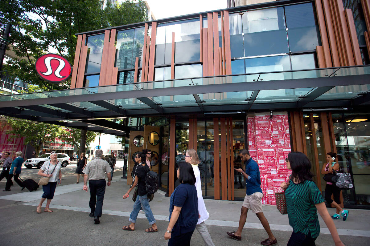 Pedestrians walk past Lululemon Athletica’s flagship store on Robson Street in downtown Vancouver, B.C., on Thursday August 21, 2014. The company is under invetigation by the Compeition Bureau Canada for allegedly misleading customers about its environmental impact. THE CANADIAN PRESS/Darryl Dyck